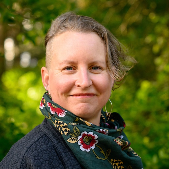 Headshot of a white woman in a floral scarf